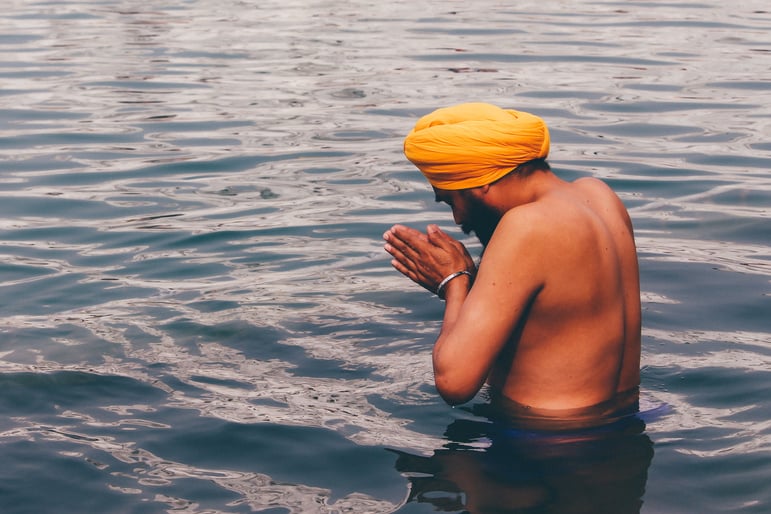 A Man Praying in the Pool at the Golden Temple of Amritsar